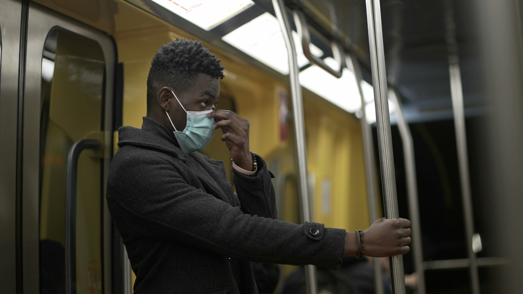 A man with a face mask in a train