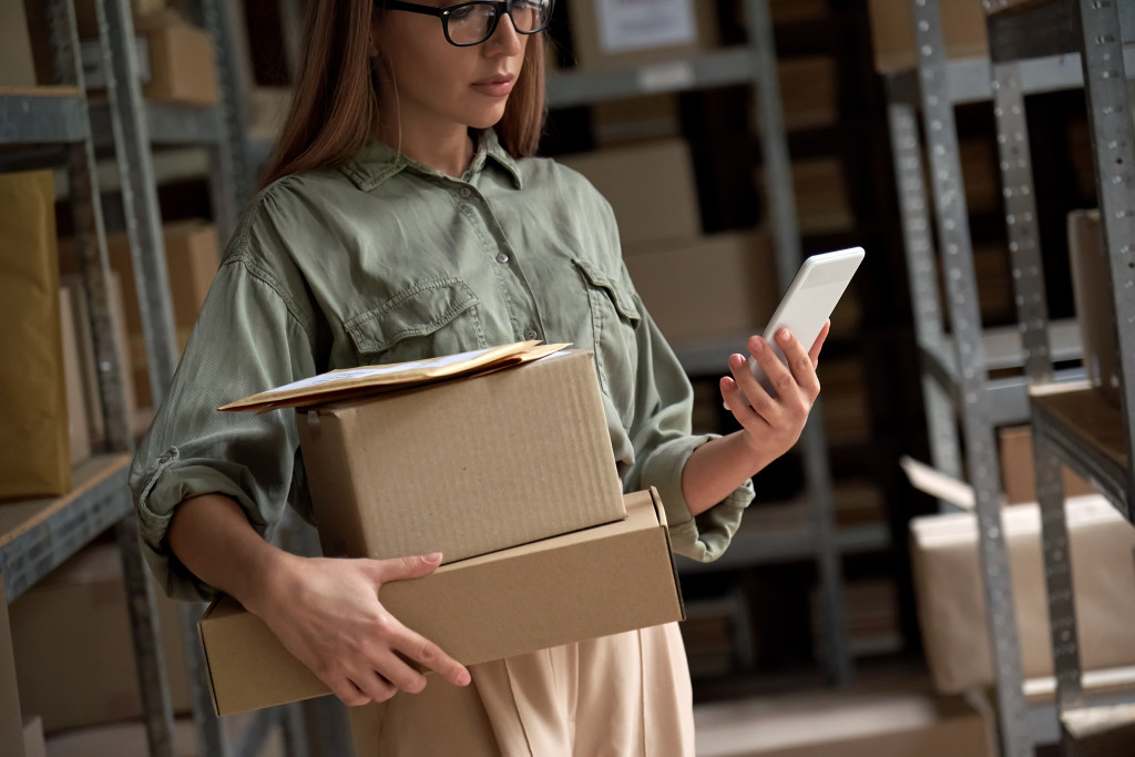 small stock business owner holding phone