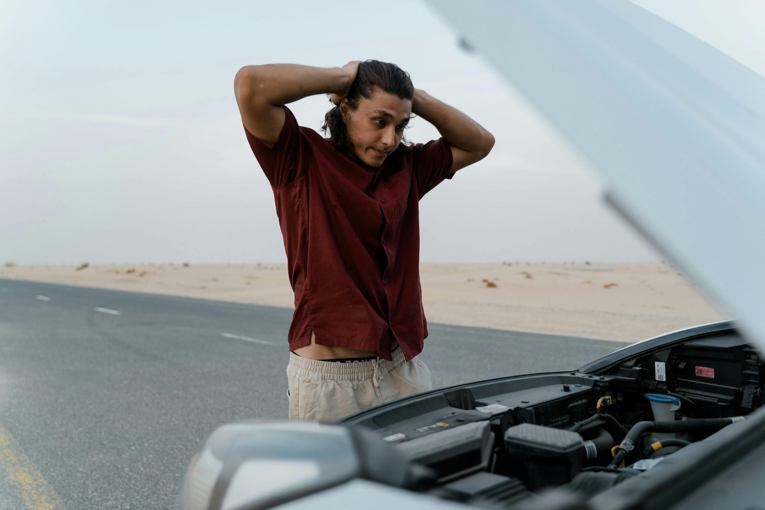 stressed man dealing with a car breakdown